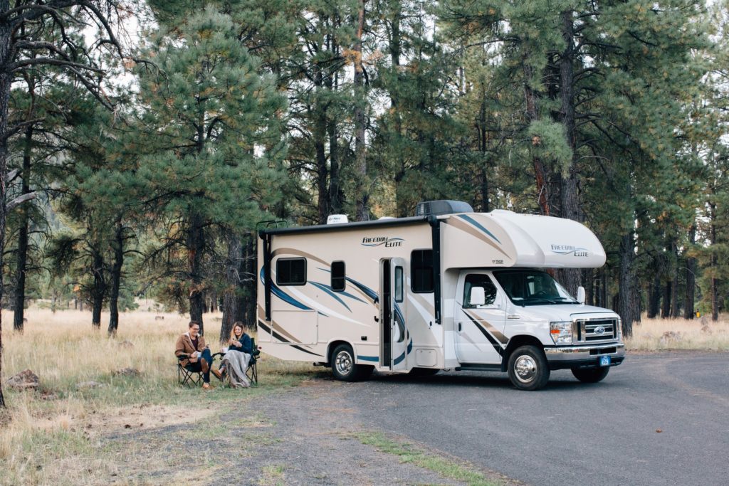 RV parked near a forest