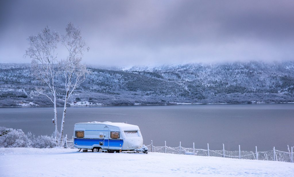 Camper by winter lake