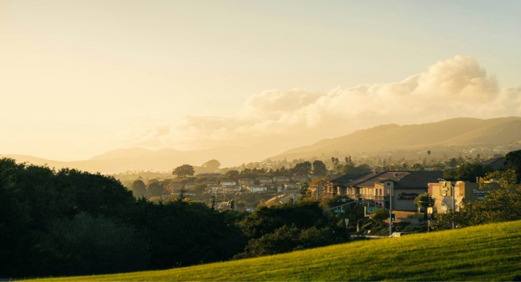 Golden hour light washing over the hillside town of Pismo Beach, California