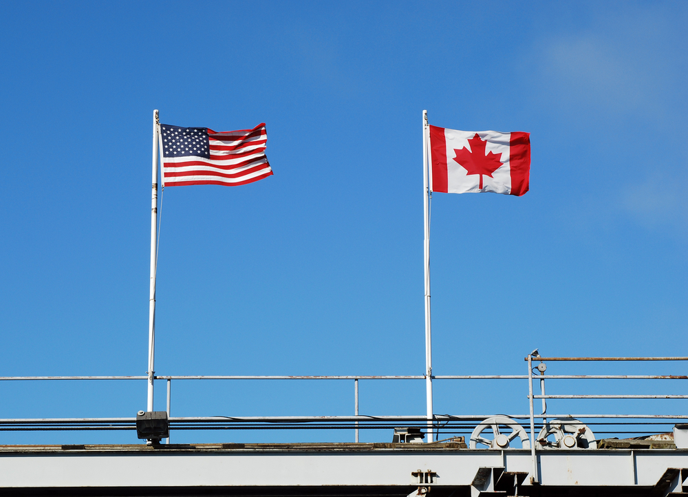 Canadian RV to the US. US and Canadian flags fly at the border