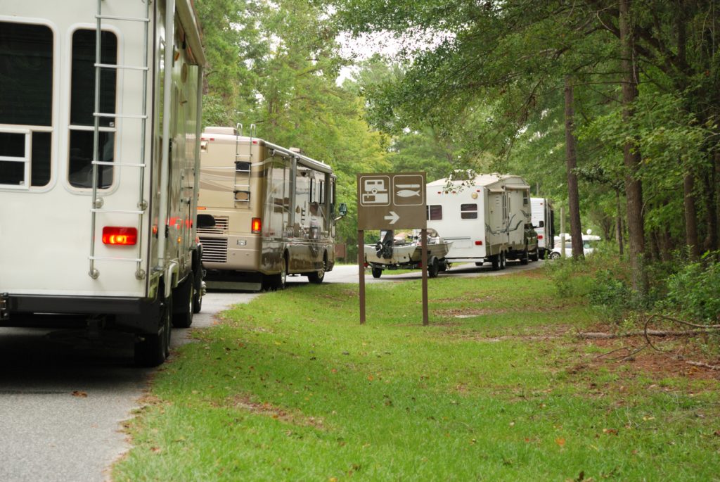 RV rental market in Canada. A line of travel trailers and motorhomes in line at campground.